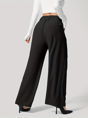 Black pleated wide-leg tailored trousers with a relaxed fit and elastic waistband.