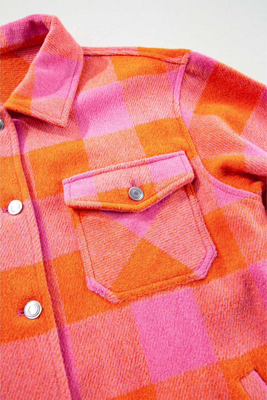 Overshirt with patch pockets in orange and pink buffalo check pattern.