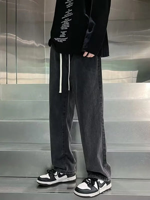 Men's gray loose-fit jeans with drawstring waist and vintage wash.