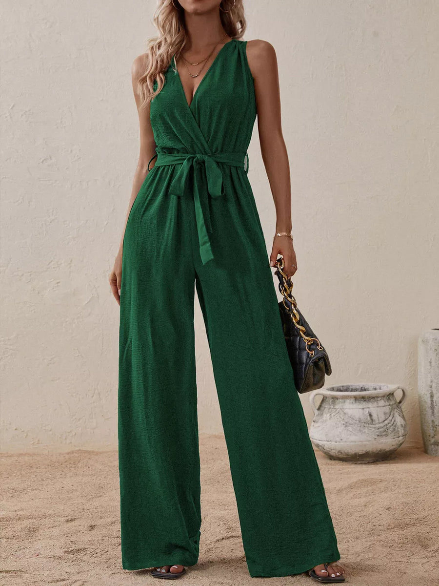 Dark green V-neck tie-waist wide-leg romper with textured fabric and sleeveless design.