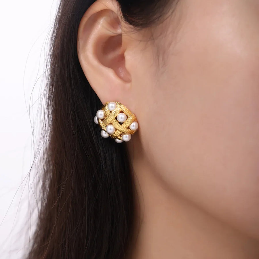 Gold woven pearl grid earrings with a textured finish.