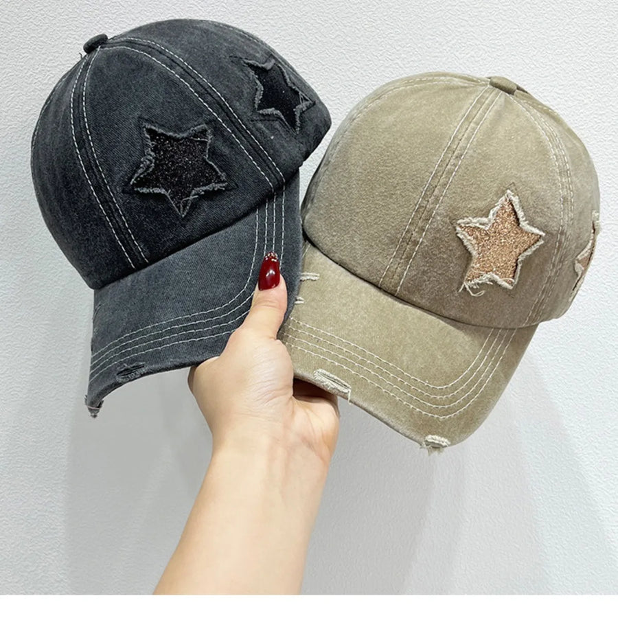 Stellar snapback baseball caps in gray and khaki with distressed details and glitter star patches.
