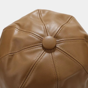 dark brown hat with stiff brim and none