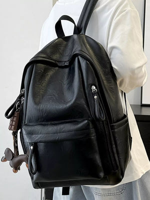 Chic black pu leather medium backpack with front pockets and zipper details.