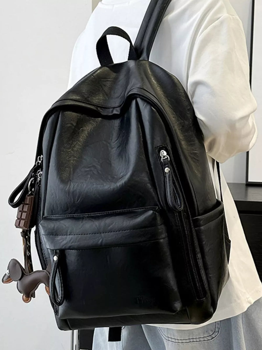 Chic black pu leather medium backpack with front pockets and zipper details.