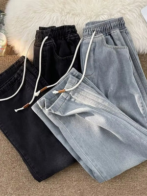 Men's wide-leg jeans in black and blue with drawstring waist and pockets.