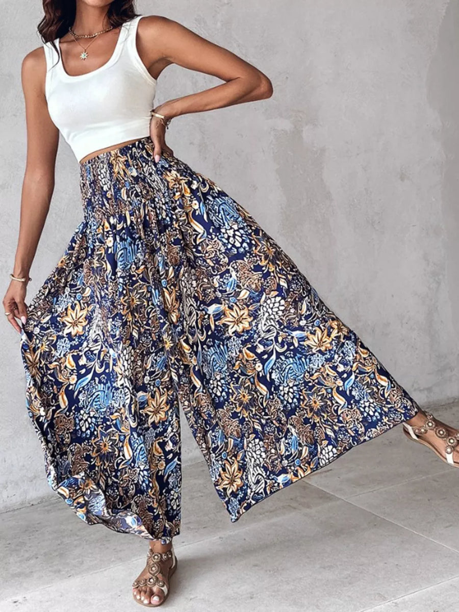 Bohemian print smocked waist wide-leg pants in dark navy with a floral pattern.
