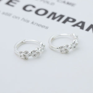 earrings in silver featuring floral embellishment and hoop fit