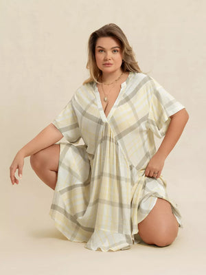 Plus size beige plaid flutter sleeve midi dress with V-neck and cinched waist