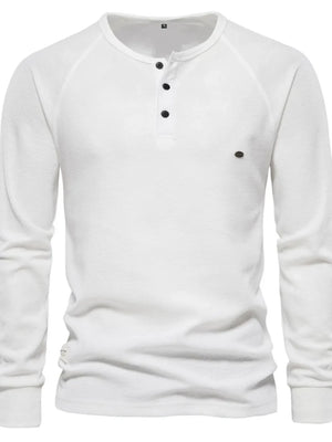 White waffle knit henley shirt with raglan sleeves and black buttons.