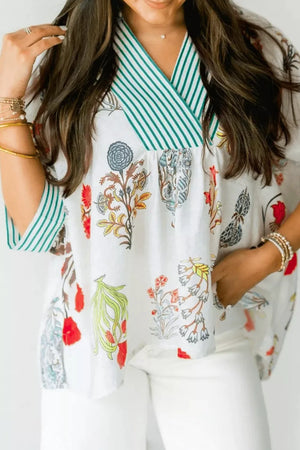 White floral print shirt with green striped contrast trim and V-neckline