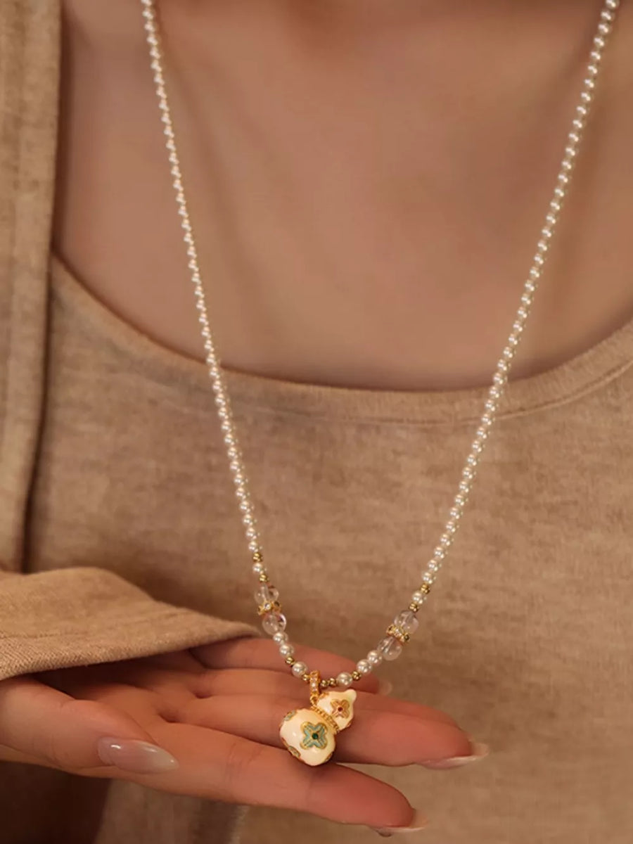 gold necklace featuring 18K gold-plated and floral