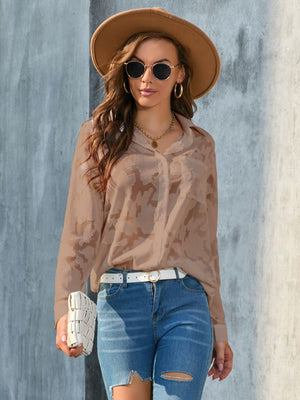 Taupe sheer button-down blouse with floral embroidery and long sleeves.