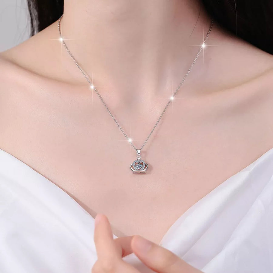silver necklace with crown pendant and none