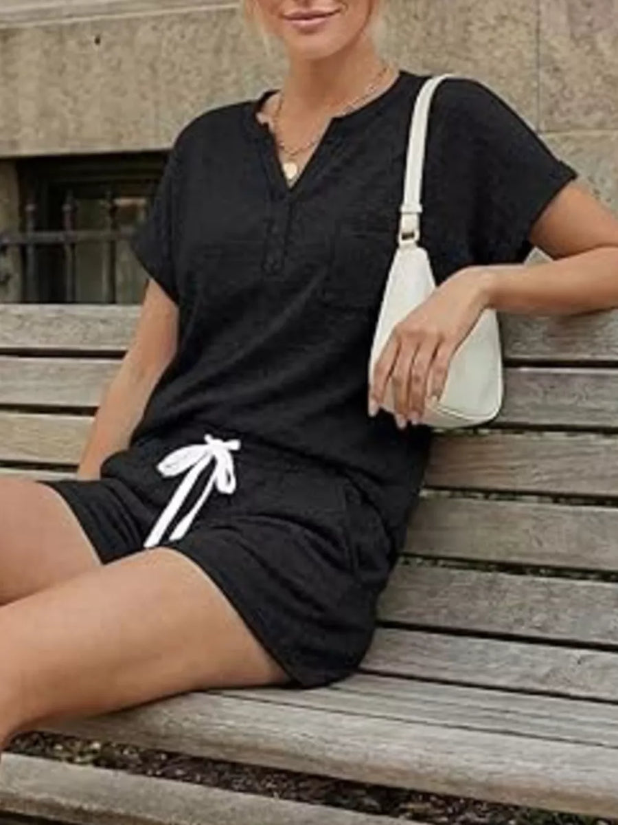 Black relaxed two-piece set with button-down henley top and drawstring shorts.