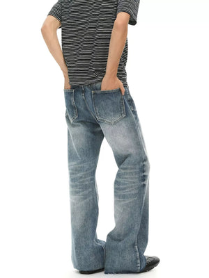 Men's light wash denim flare jeans with distressed details and a relaxed fit.