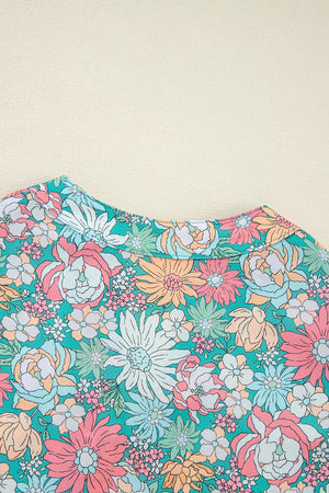 Floral peplum blouse with scallop trim and a colorful floral print.