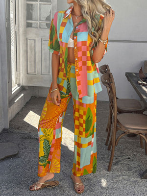 Women's multicolor abstract print resort co-ord set with wide leg pants and button-up shirt.