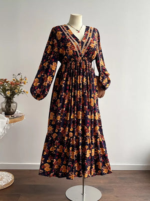 Maxi dress with floral print, V-neck, long sleeves, tiered skirt, and lace trim.
