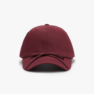Burgundy baseball cap with a tied bow detail on the back.