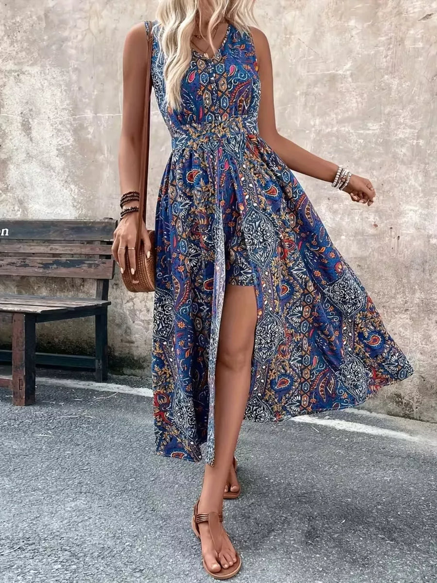 Peacock blue paisley print overlay romper with cinched waist and dramatic slit.