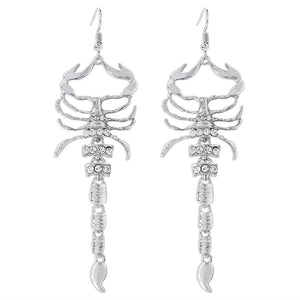 Gold earrings with fish hook and animal motif