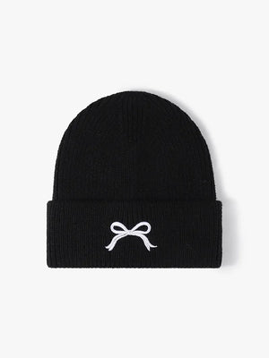 Black ribbed knit beanie with embroidered white bow detail