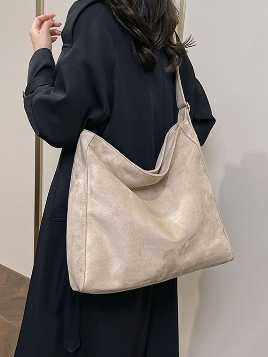 crossbody bag in light beige featuring adjustable straps and relaxed fit