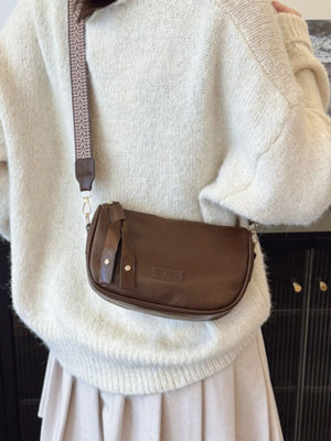 Retro shoulder crossbody bag in coffee brown with tassel detail and patterned strap.