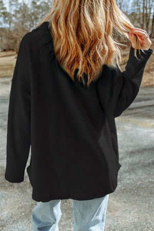 Black button-up coat with textured fabric and pockets