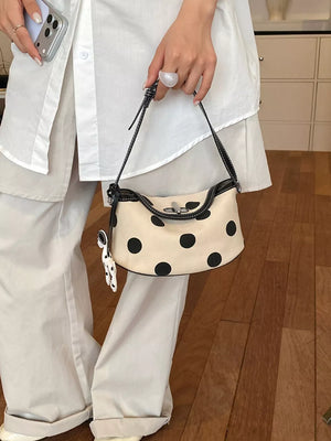 shoulder bag in black with polka-dot and flap closure