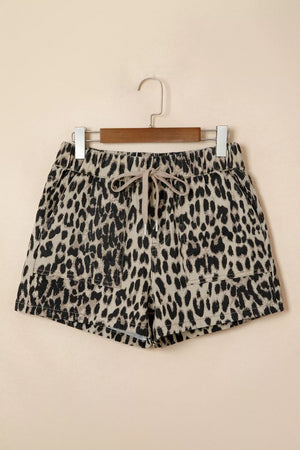 Denim shorts with leopard print, drawstring waist, and pockets.
