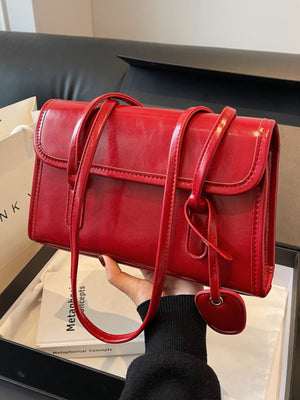 shoulder bag in Wine Red with flap closure and small