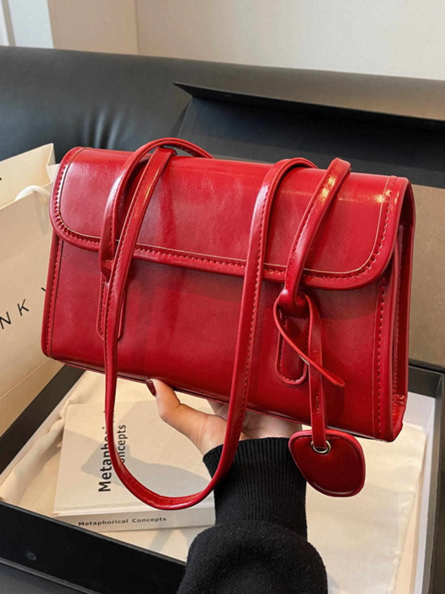 shoulder bag in Wine Red with flap closure and small