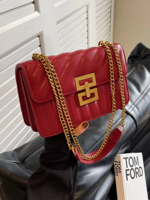 Chic quilted crossbody bag in wine red with gold chain and clasp.