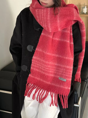 Chic pink striped scarf with fringe hem and fuzzy texture.