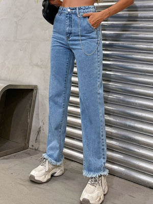 Light wash denim jeans with frayed hem and chain detail