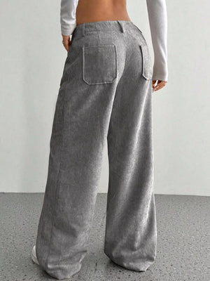Grey corduroy wide-leg trousers with back pockets and a relaxed fit.
