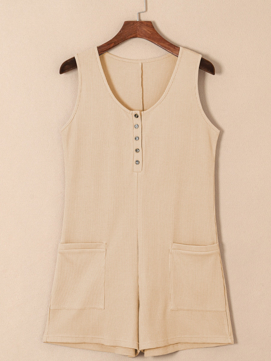 Camel waffle knit button-down romper with pockets and a scoop neck.