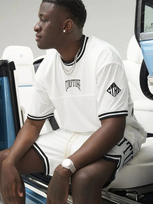 White mesh athletic shorts with black trim and logo detail