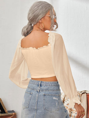 Tan bustier blouse with square neckline, ruffled trim, and sheer bishop sleeves.