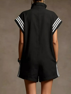 Black sporty romper with white stripes on sleeves and sides, zip-up collar, short sleeves.