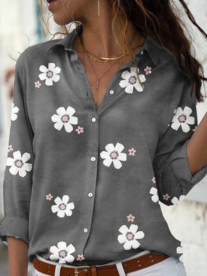 Pink button-down shirt featuring buttoned and floral