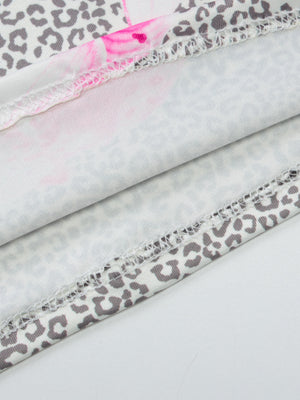 Lace-trimmed leopard print camisole with pink floral accents and serged hem detail.