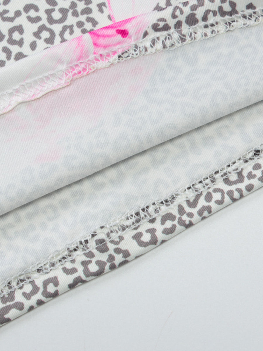Lace-trimmed leopard print camisole with pink floral accents and serged hem detail.