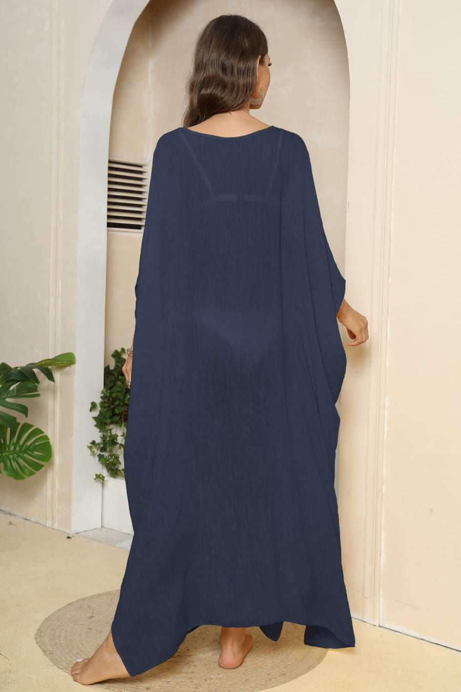 Dark blue oversized caftan cover-up with side slits and wide sleeves.