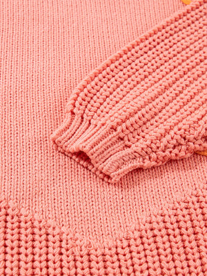 Burnt Coral knit sweater with textured sleeve cuff and hem detail.
