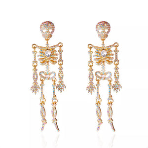earrings in Gold with skeleton and zircon embellishment
