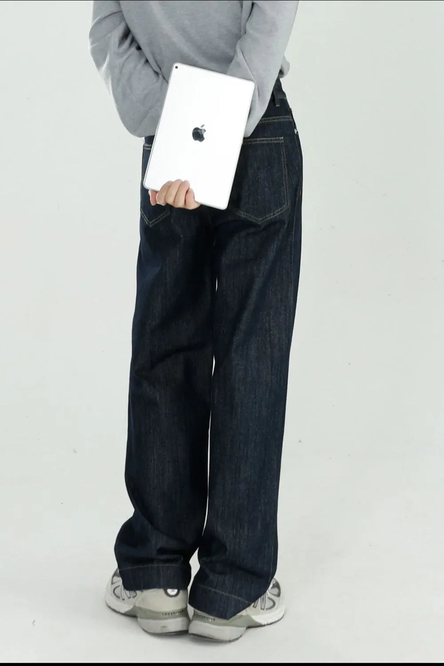 Dark wash wide-leg denim jeans with a relaxed fit, shown from the back.