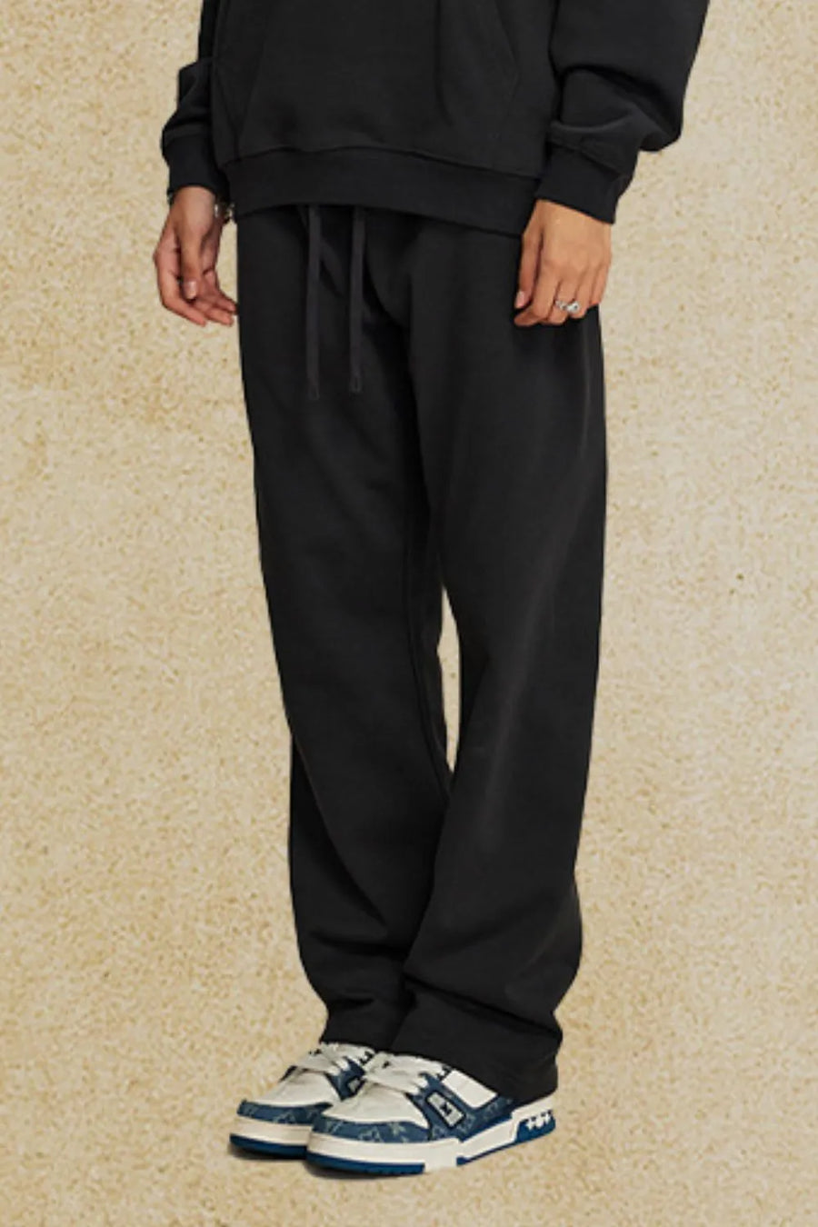 Black relaxed fit joggers with drawstring waist and cuffed ankles.